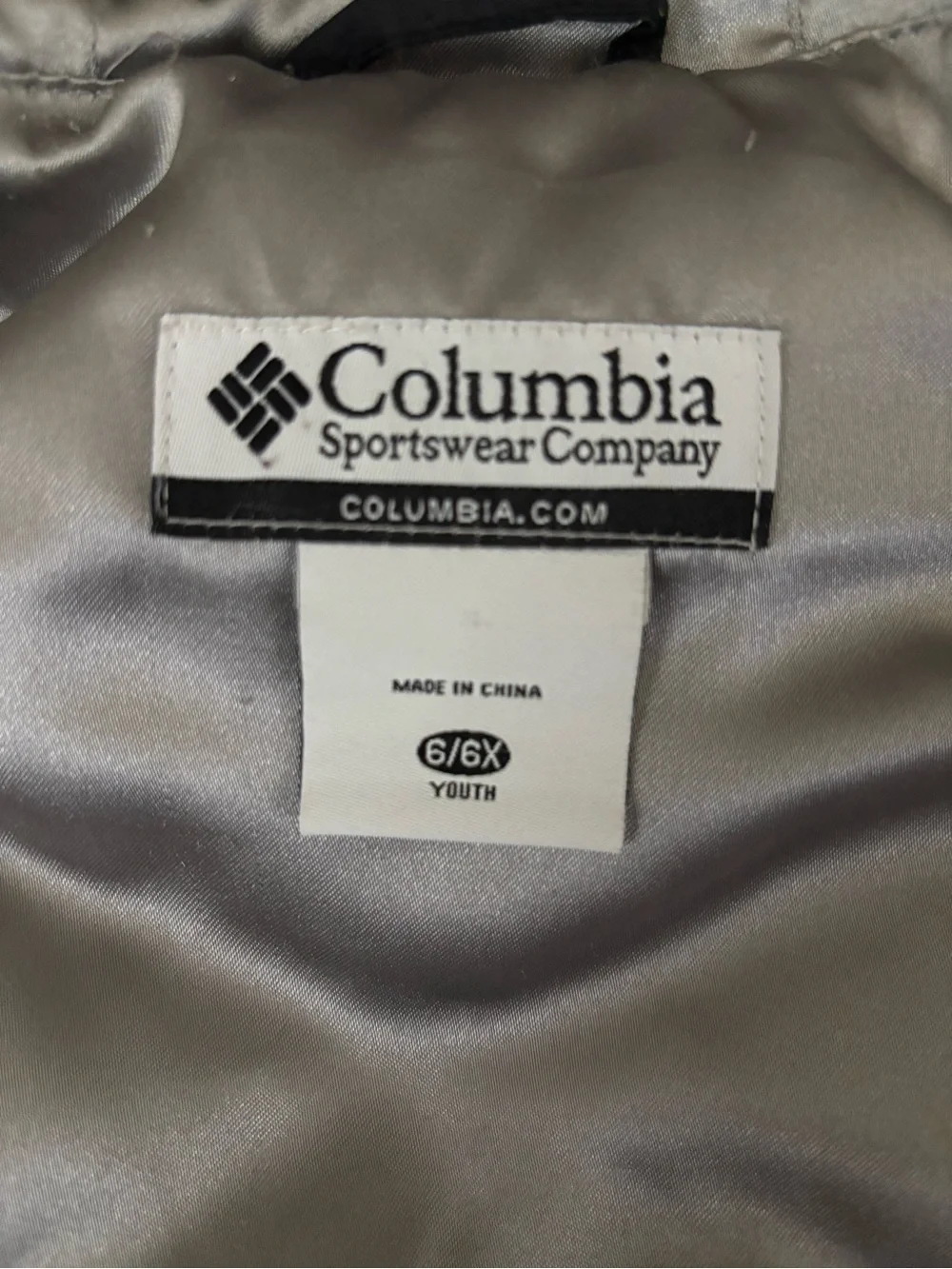 Columbia Kids Black Hooded Vest with Silver Lining and fleur-de-lis.
